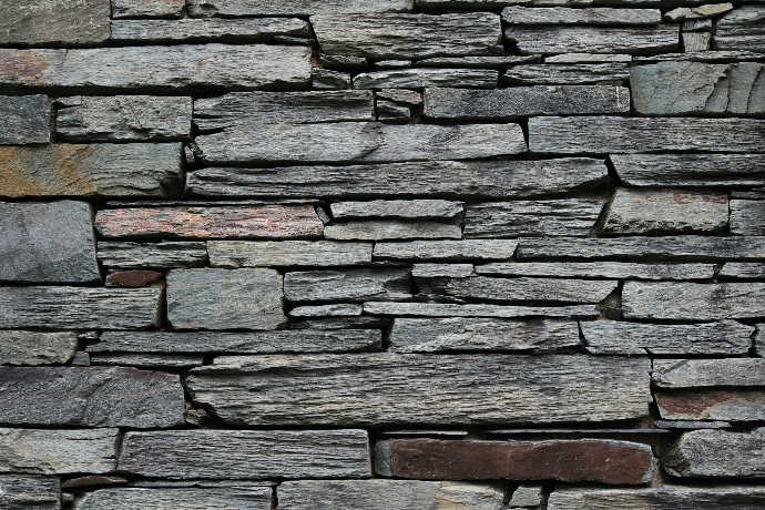 minimalist photography of gray rock wall